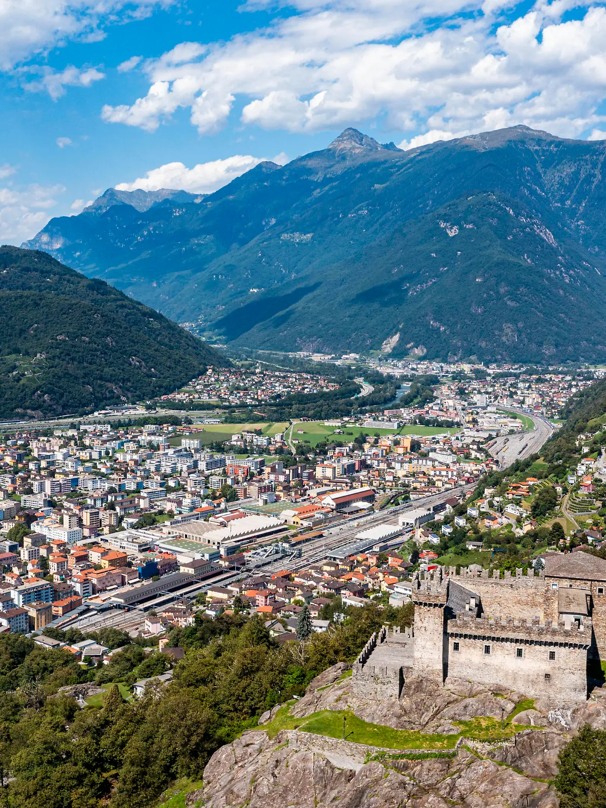 Switzerland, Ticino, Bellinzona, Aerial view of Sasso Corbaro castle overlooking town below RUNF04669 
