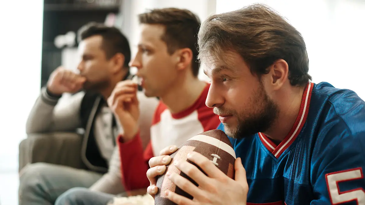Focused watching football game at home