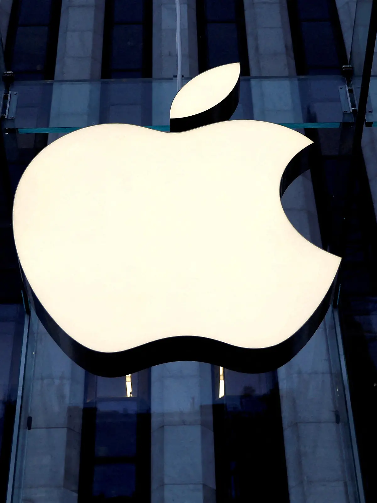 FILE PHOTO: The Apple Inc. logo is seen hanging at the entrance to the Apple store on 5th Avenue in Manhattan, New York, U.S., October 16, 2019. REUTERS/Mike Segar/File Photo