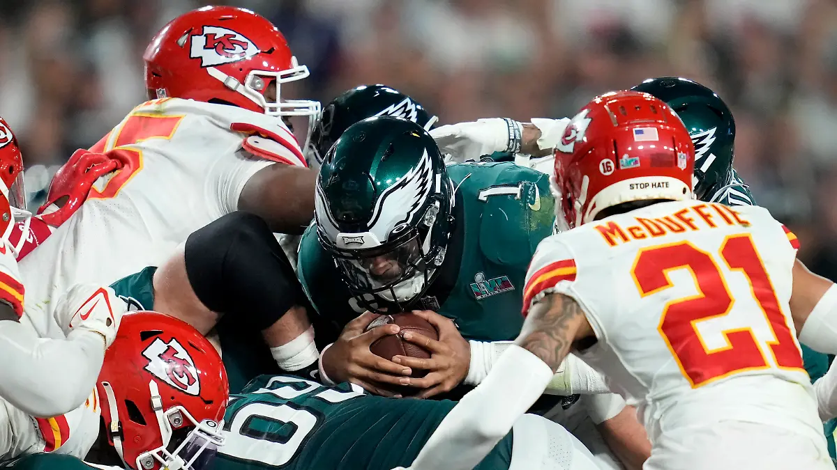 Philadelphia Eagles quarterback Jalen Hurts (1) pushes for the first down against the Kansas City Chiefs during the second half of the NFL Super Bowl 57 football game, Sunday, Feb. 12, 2023, in Glendale, Ariz. (AP Photo/Ashley Landis)