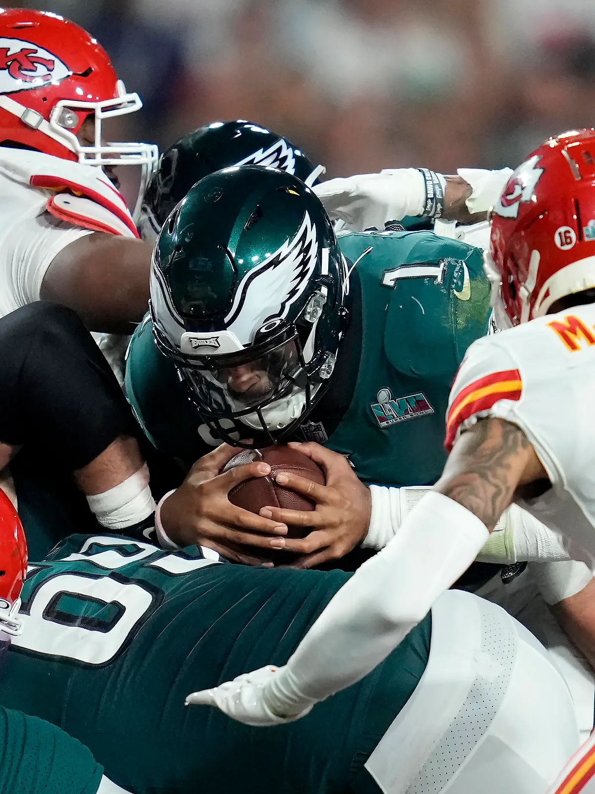 Philadelphia Eagles quarterback Jalen Hurts (1) pushes for the first down against the Kansas City Chiefs during the second half of the NFL Super Bowl 57 football game, Sunday, Feb. 12, 2023, in Glendale, Ariz. (AP Photo/Ashley Landis)