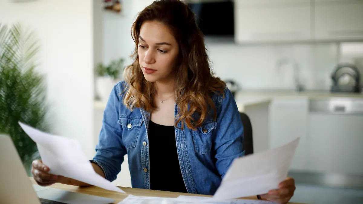 Serious young woman working at home