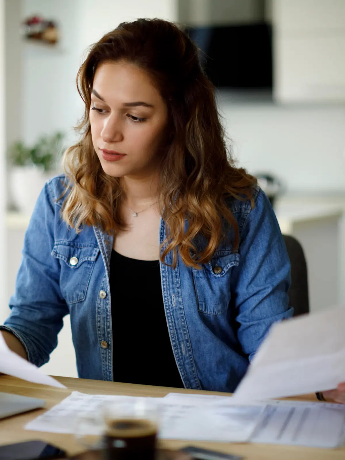Serious young woman working at home