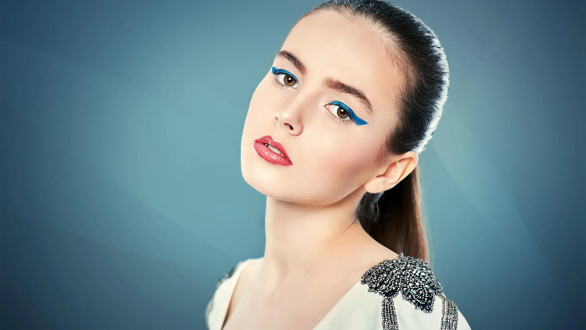 Fashion  shot.  Portrait  of  a  beautiful  young  woman  in  white  jacket  on  a  grey  background.  Trendy  makeup  with  blue  aquamarine  eye  arrows.  Make-up  and  cosmetics. Model Released Property Released xkwx aquamarine,  arrows,  attractive,  beautiful,  beauty,  blouse,  blue,  bright,  caucasian,  clothes,  color,  copy  space,  cosmetics,  elegant,  eyebrows,  eyeliner,  eyes,  face,  fashion,  fashionable,  female,  girl,  gorgeous,  gray,  hair,  hairstyle,  jacket,  lady,  light,  lips,  lipstick,  makeup,  model,  modern,  people,  portrait,  sensual,  sexy,  skin,  style,  stylish,  summer,  trendy,  vivid,  vogue,  white,  woman,  young