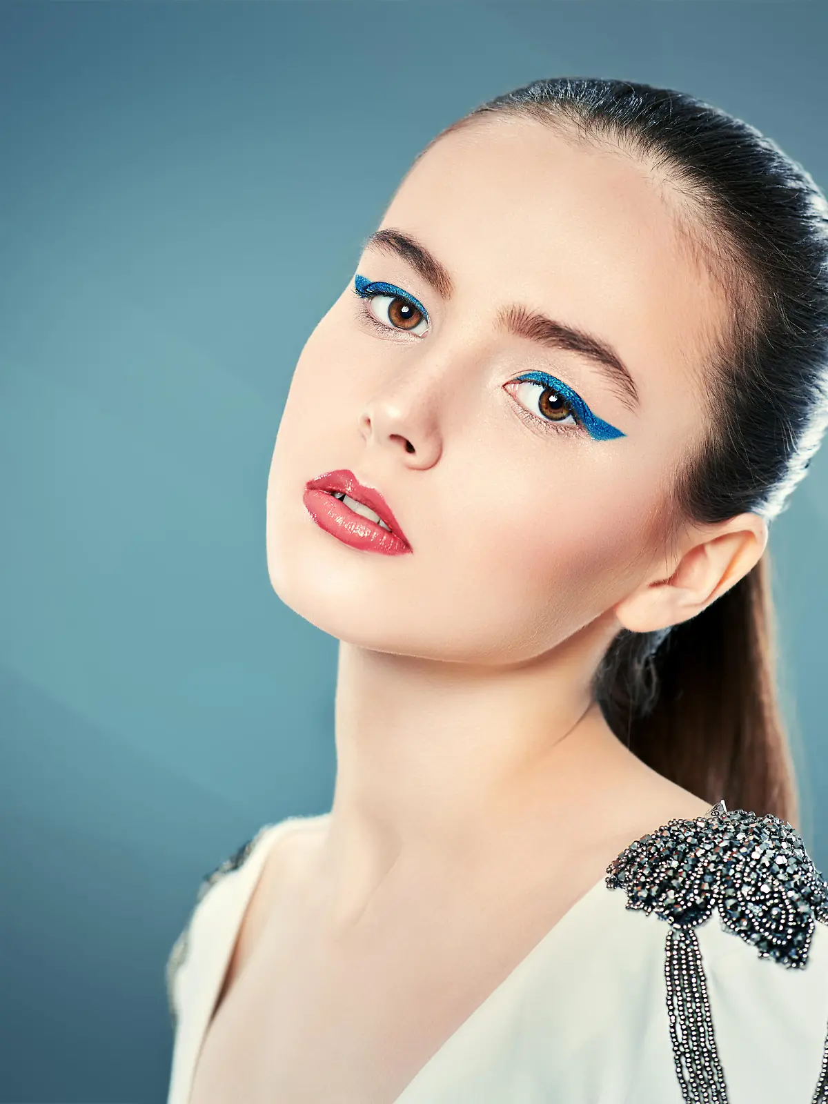Fashion  shot.  Portrait  of  a  beautiful  young  woman  in  white  jacket  on  a  grey  background.  Trendy  makeup  with  blue  aquamarine  eye  arrows.  Make-up  and  cosmetics. Model Released Property Released xkwx aquamarine,  arrows,  attractive,  beautiful,  beauty,  blouse,  blue,  bright,  caucasian,  clothes,  color,  copy  space,  cosmetics,  elegant,  eyebrows,  eyeliner,  eyes,  face,  fashion,  fashionable,  female,  girl,  gorgeous,  gray,  hair,  hairstyle,  jacket,  lady,  light,  lips,  lipstick,  makeup,  model,  modern,  people,  portrait,  sensual,  sexy,  skin,  style,  stylish,  summer,  trendy,  vivid,  vogue,  white,  woman,  young