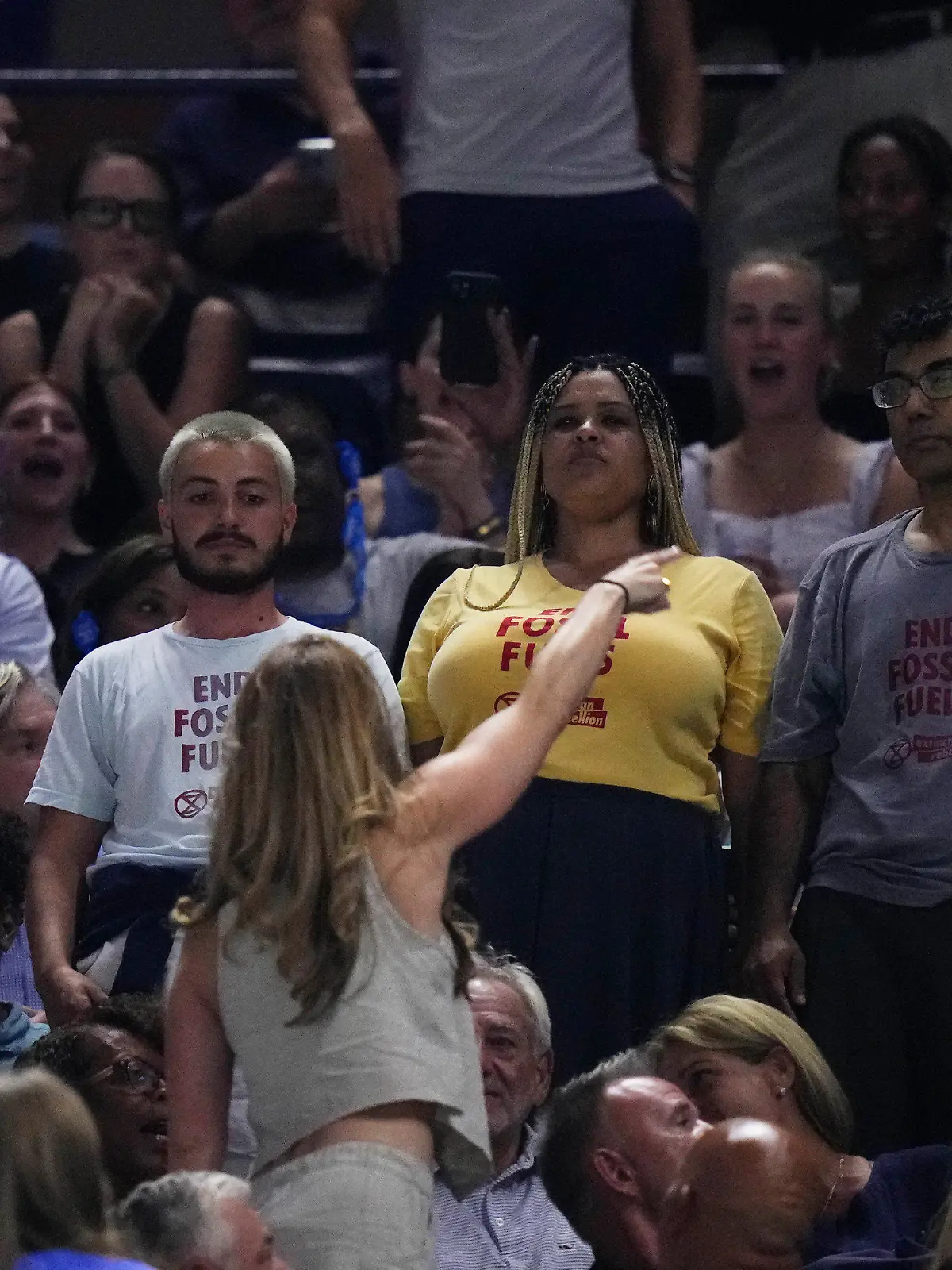 An audience member yells at protesters as they demonstrate at a match between Coco Gauff, of the United States, and Karolina Muchova, of the Czech Republic, during the women's singles semifinals of the U.S. Open tennis championships, Thursday, Sept. 7, 2023, in New York. (AP Photo/Frank Franklin II)