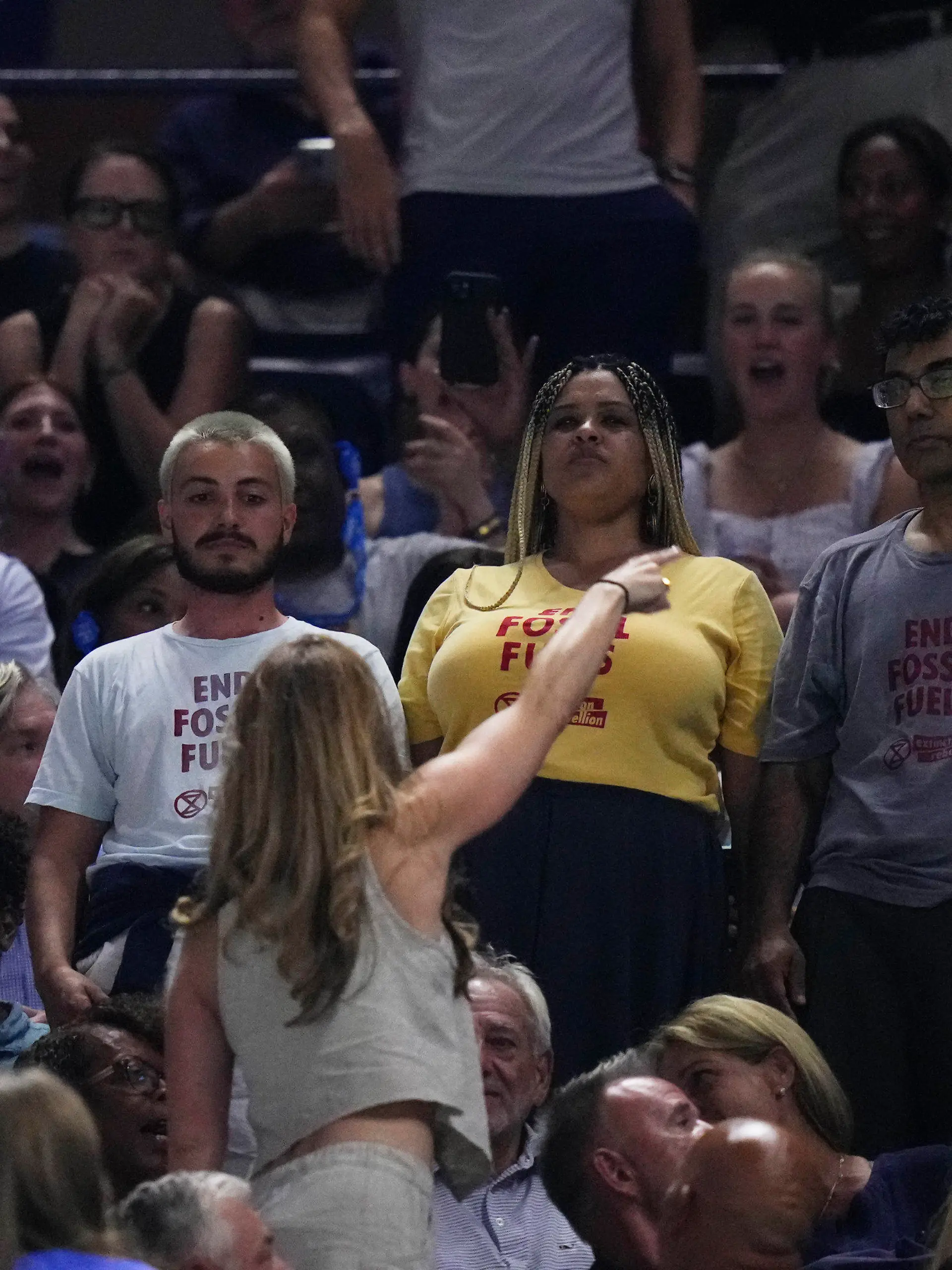 An audience member yells at protesters as they demonstrate at a match between Coco Gauff, of the United States, and Karolina Muchova, of the Czech Republic, during the women's singles semifinals of the U.S. Open tennis championships, Thursday, Sept. 7, 2023, in New York. (AP Photo/Frank Franklin II)