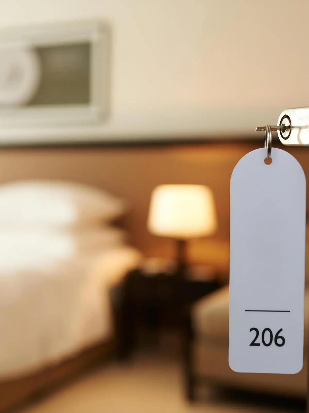 Opened door of hotel room with key in the lock