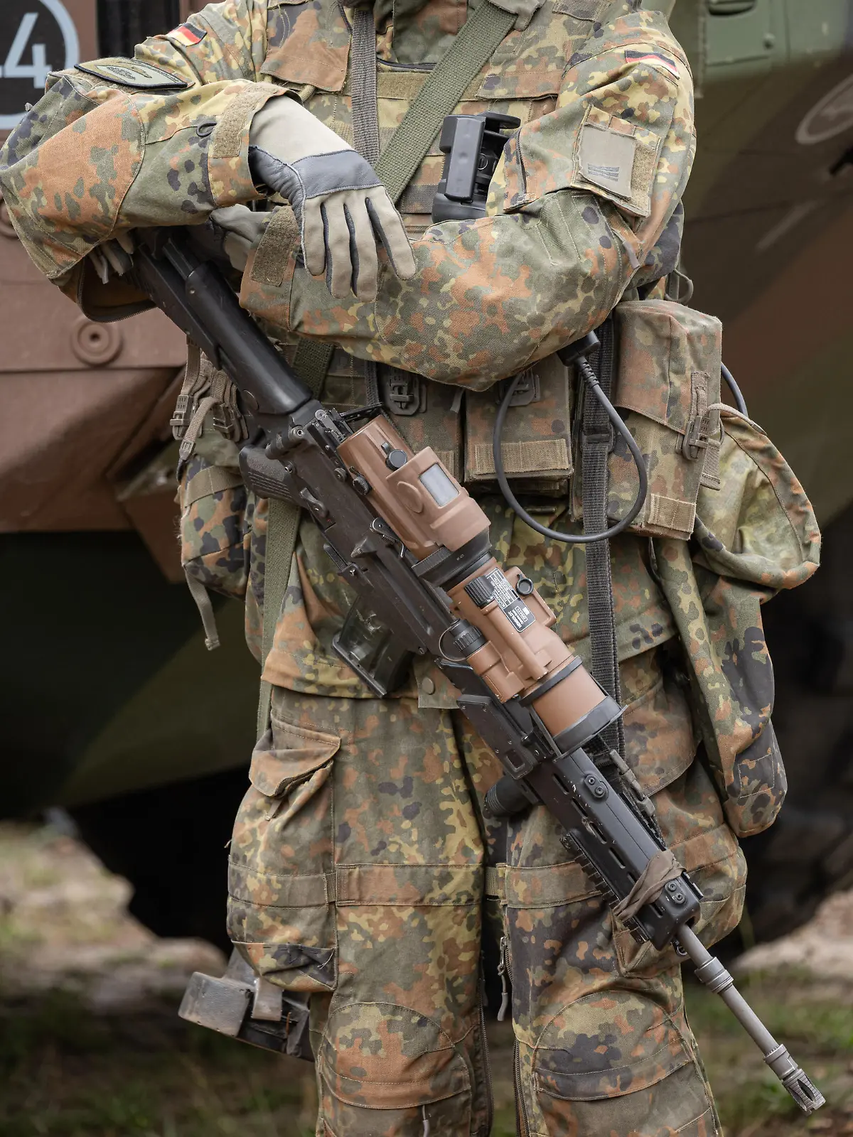 Ein bewaffneter Grenadier im Ausrüstungszustand steht auf dem Bundeswehrgelände in Munster vor einem GTK Boxer.