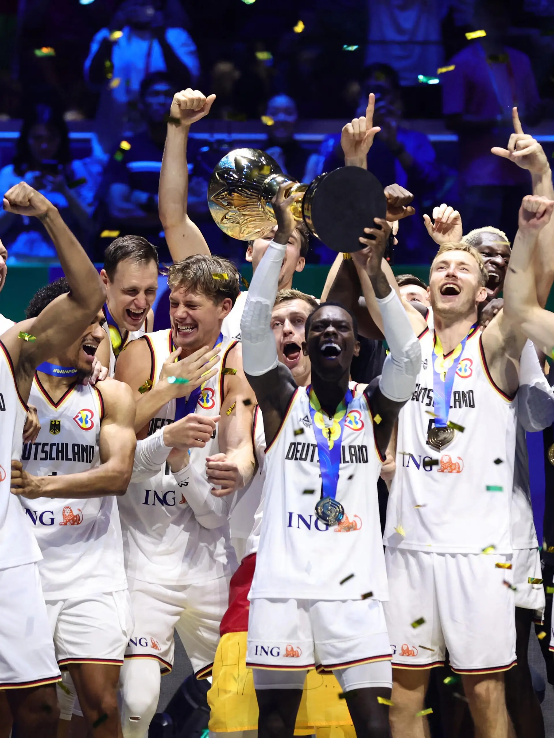 Basketball - FIBA World Cup 2023 - Final - Germany v Serbia - Mall of Asia Arena, Manila, Philippines - September 10, 2023 Germany's Dennis Schroder lifts the trophy with teammates after winning the FIBA World Cup 2023 Final REUTERS/Eloisa Lopez