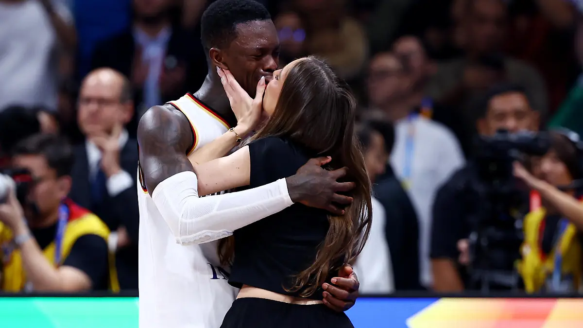 MANILA, PHILIPPINES - SEPTEMBER 10: Dennis Schroder #17 of Germany kisses his wife Ellen Ziolo after the FIBA Basketball World Cup Final victory over Serbia at Mall of Asia Arena on September 10, 2023 in Manila, Philippines. Germany won 83-77. (Photo by Yong Teck Lim/Getty Images)