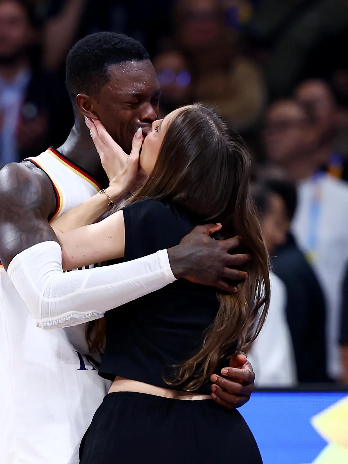 MANILA, PHILIPPINES - SEPTEMBER 10: Dennis Schroder #17 of Germany kisses his wife Ellen Ziolo after the FIBA Basketball World Cup Final victory over Serbia at Mall of Asia Arena on September 10, 2023 in Manila, Philippines. Germany won 83-77. (Photo by Yong Teck Lim/Getty Images)