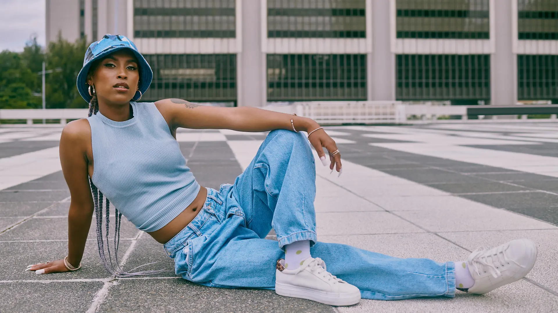 Shot of a trendy young woman posing against a city background