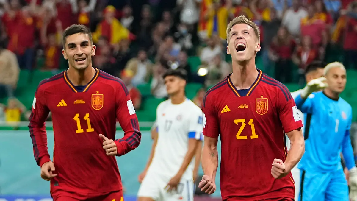 Spain's Dani Olmo, right, celebrates after scoring a goal during the World Cup group E soccer match between Spain and Costa Rica, at the Al Thumama Stadium in Doha, Qatar, Wednesday, Nov. 23, 2022. (AP Photo/Julio Cortez)
