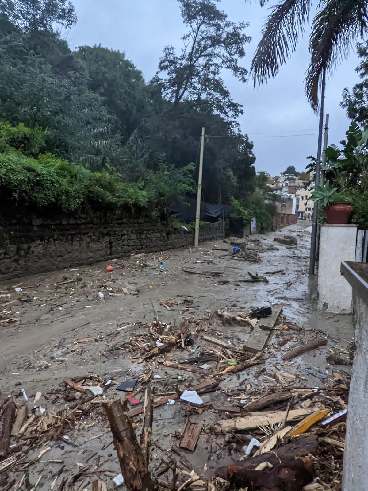 Debris are seen on the street, following a landslide on the Italian holiday island of Ischia, Italy, in this handout photo obtained by Reuters on November 26, 2022. Carabinieri/Handout via REUTERS THIS IMAGE HAS BEEN SUPPLIED BY A THIRD PARTY.