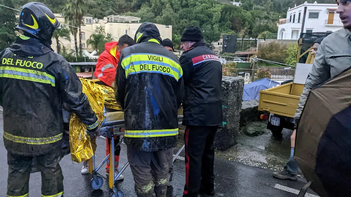 Rescuers help an injured person following a landslide on the Italian holiday island of Ischia, Italy, in this handout photo obtained by Reuters on November 26, 2022. Carabinieri/Handout via REUTERS THIS IMAGE HAS BEEN SUPPLIED BY A THIRD PARTY.