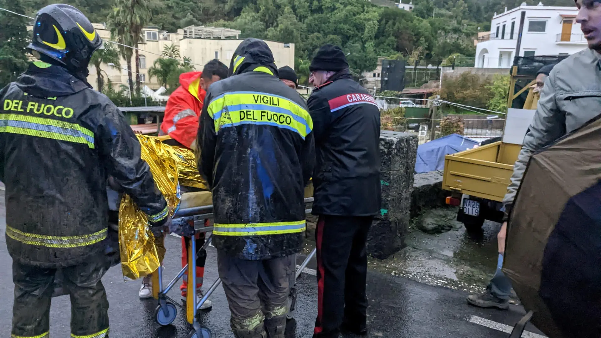 Rescuers help an injured person following a landslide on the Italian holiday island of Ischia, Italy, in this handout photo obtained by Reuters on November 26, 2022. Carabinieri/Handout via REUTERS THIS IMAGE HAS BEEN SUPPLIED BY A THIRD PARTY.