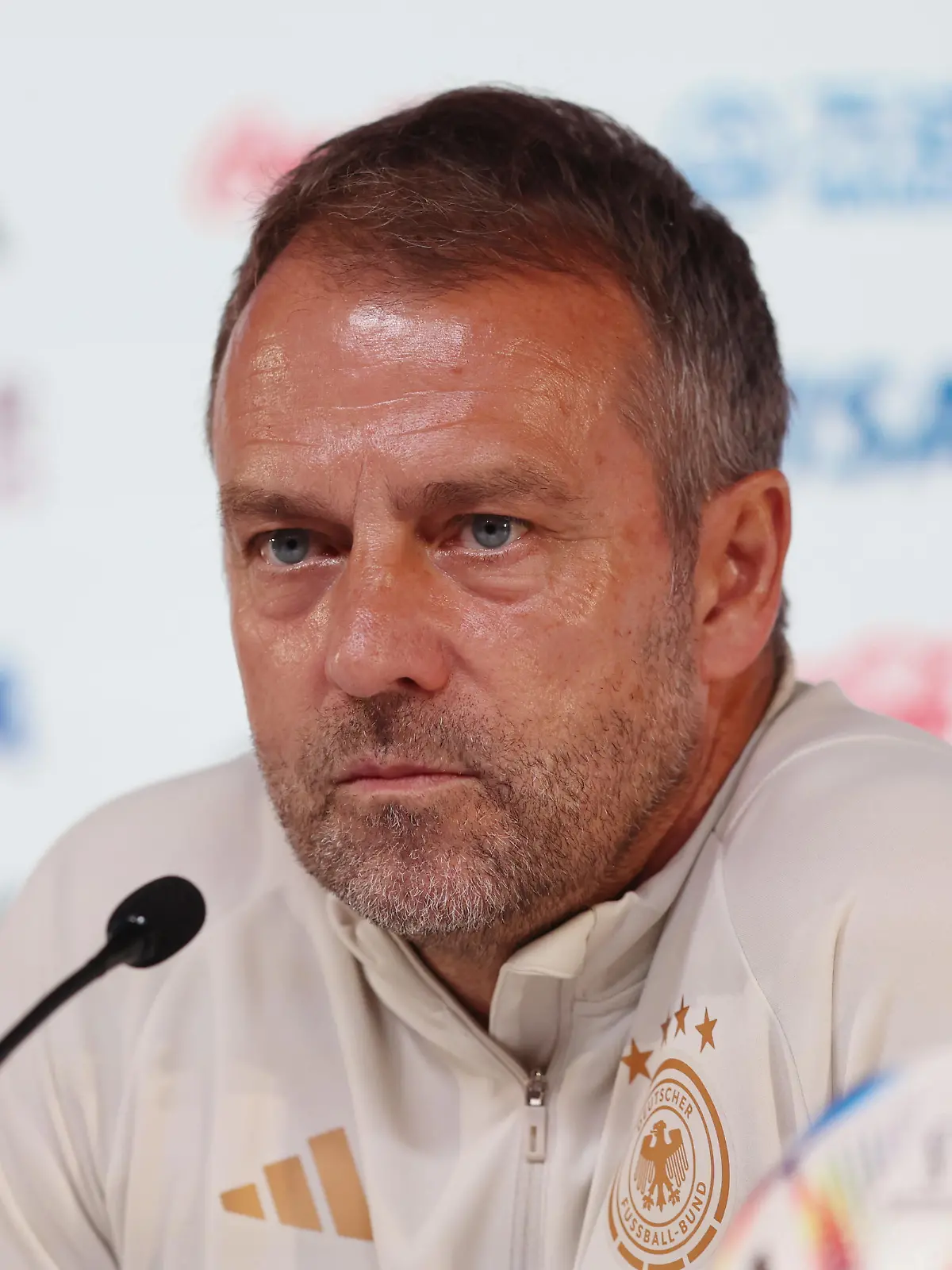 DOHA, QATAR - NOVEMBER 26: Hansi Flick, Head Coach of Germany, speaks during the Germany Press Conference at the Main Media Center on November 26, 2022 in Doha, Qatar. (Photo by Mohamed Farag/2022 Getty Images)