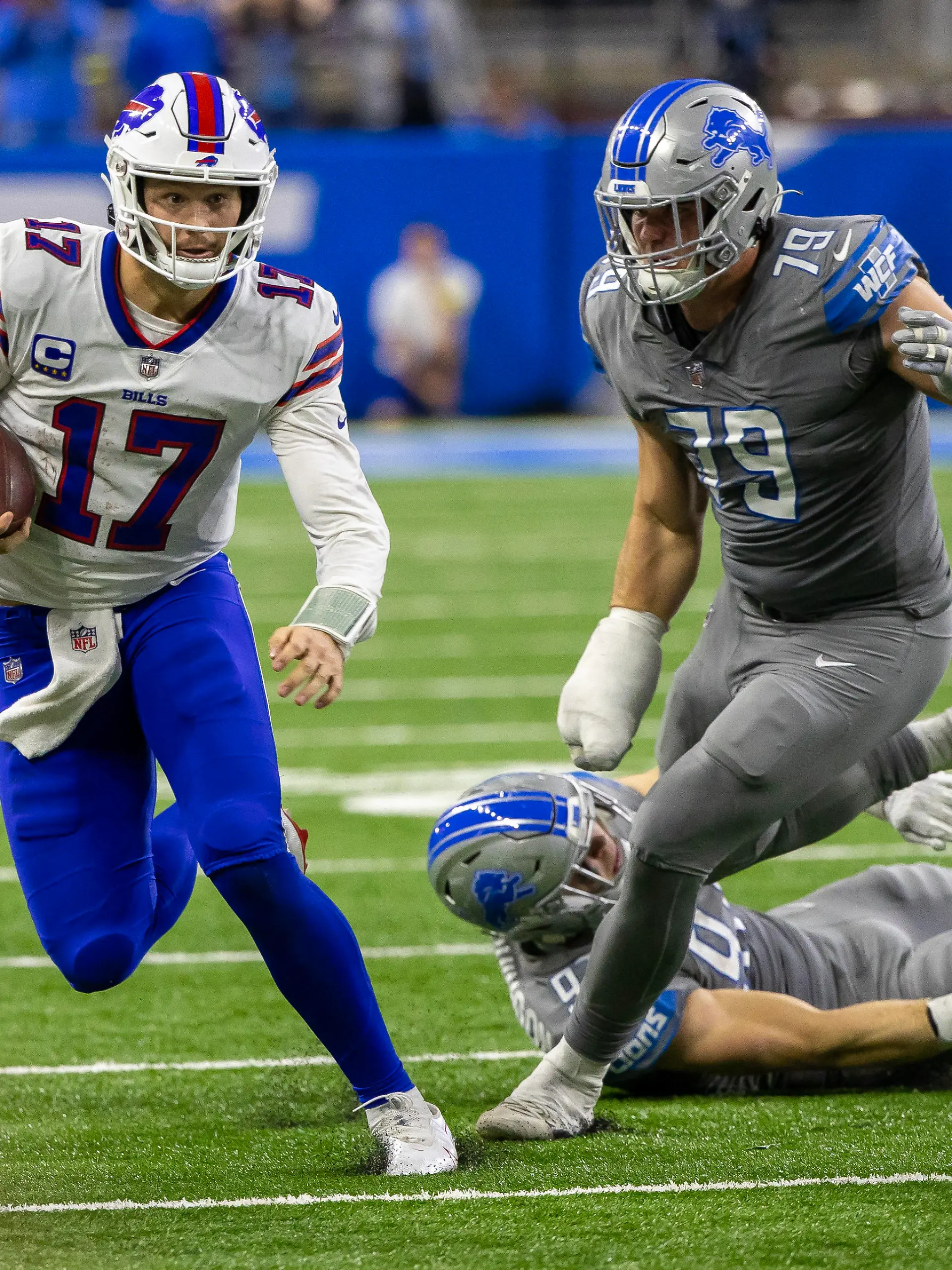 Nov 24, 2022; Detroit, Michigan, USA; Buffalo Bills quarterback Josh Allen (17) runs past Detroit Lions defensive end John Cominsky (79) during the second half at Ford Field. Mandatory Credit: David Reginek-USA TODAY Sports