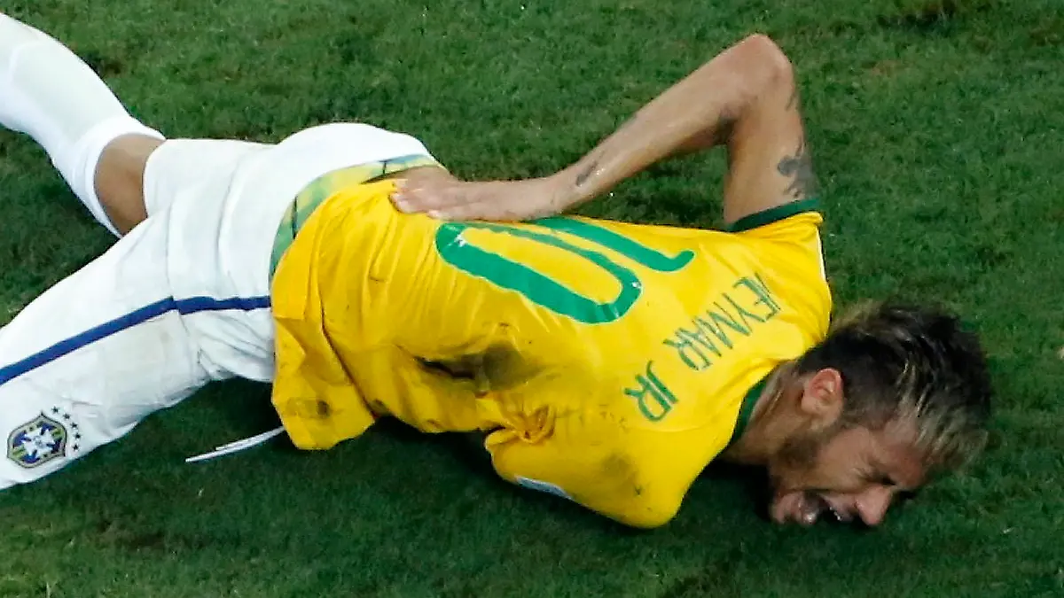 Brazil's Neymar grimaces in pain after a challenge by Colombia's Camilo Zuniga during their 2014 World Cup quarter-final match at the Castelao arena in Fortaleza July 4, 2014. Neymar has been ruled out of the remainder of the World Cup after suffering a fractured vertebrae in their quarter-final win over Colombia on Friday, the team doctor said. REUTERS/Fabrizio Bensch (BRAZIL - Tags: SPORT SOCCER WORLD CUP)