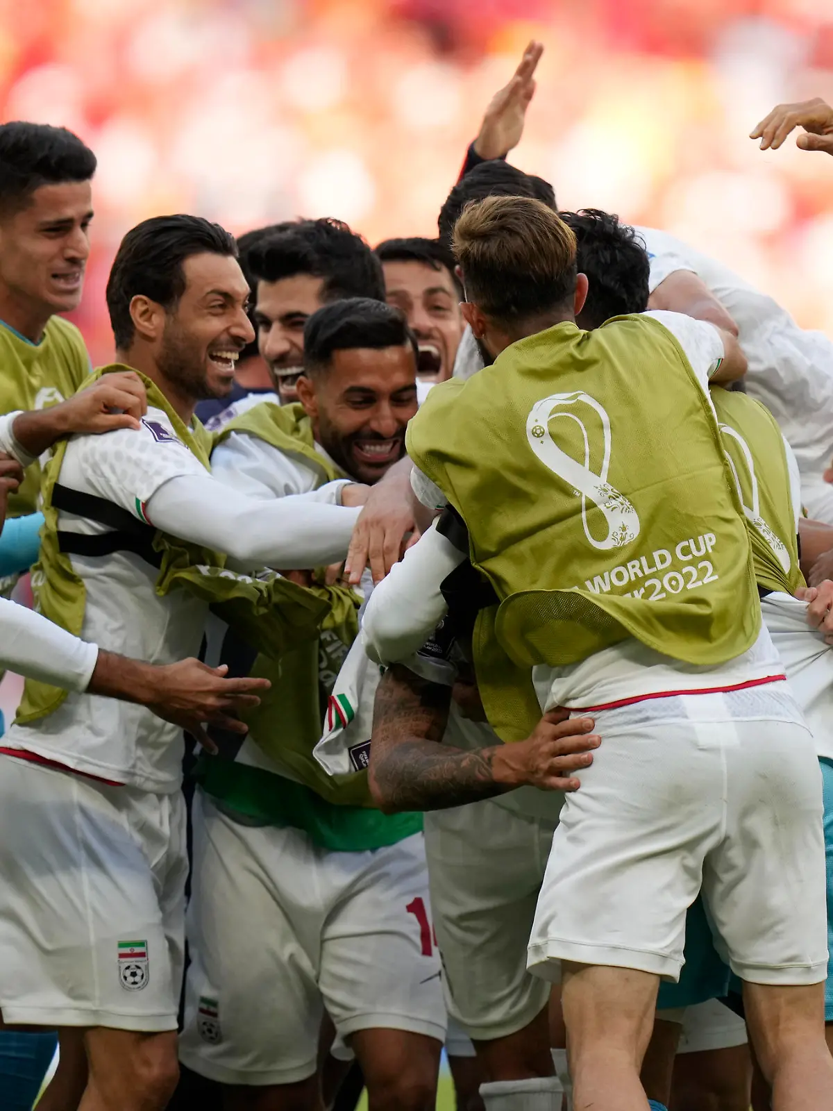 Iran teammates celebrate after scoring a goal during the World Cup group B soccer match between Wales and Iran, at the Ahmad Bin Ali Stadium in Al Rayyan, Qatar, Friday, Nov. 25, 2022. (AP Photo/Francisco Seco)