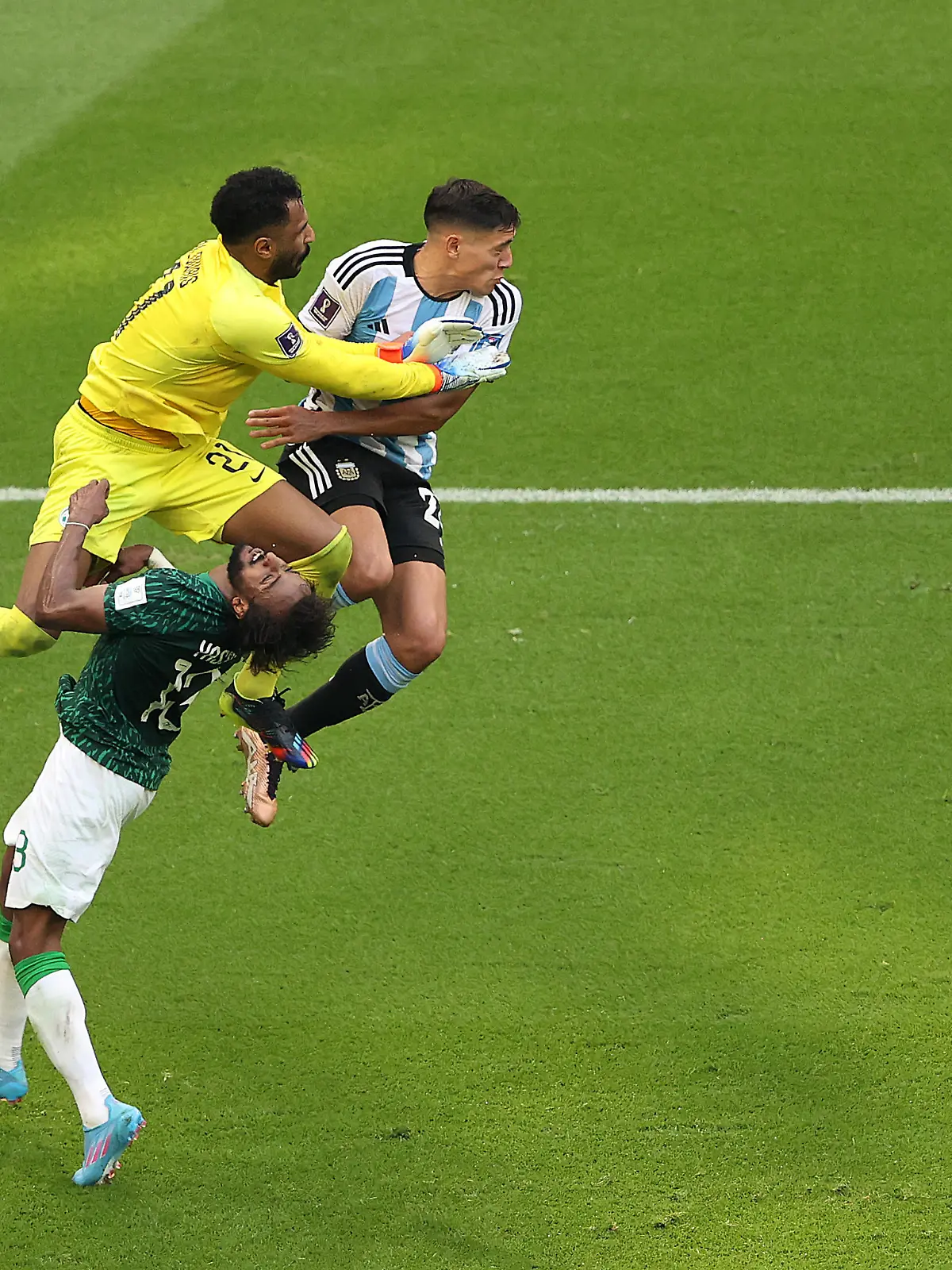 LUSAIL CITY, QATAR - NOVEMBER 22: Mohammed Al-Owais (L) of Saudi Arabia collides with teammate Yasser Al-Shahrani during the FIFA World Cup Qatar 2022 Group C match between Argentina and Saudi Arabia at Lusail Stadium on November 22, 2022 in Lusail City, Qatar. (Photo by Julian Finney/Getty Images)