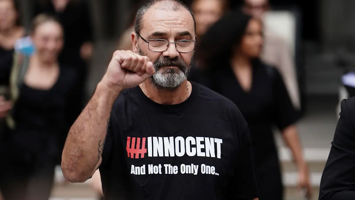 Andrew Malkinson raises a fist outside the Royal Courts of Justice in London, Britain, Wednesday, July 26, 2023. A British man who served nearly 17 years for rape has had his conviction quashed by the country’s Court of Appeal after recently-obtained DNA evidence linked another potential suspect to the crime. Andrew Malkinson, 57, was found guilty of the brutal 2003 attack on a woman in Greater Manchester and jailed for life the following year, with a minimum term of seven years. (Jordan Pettitt/PA via AP)