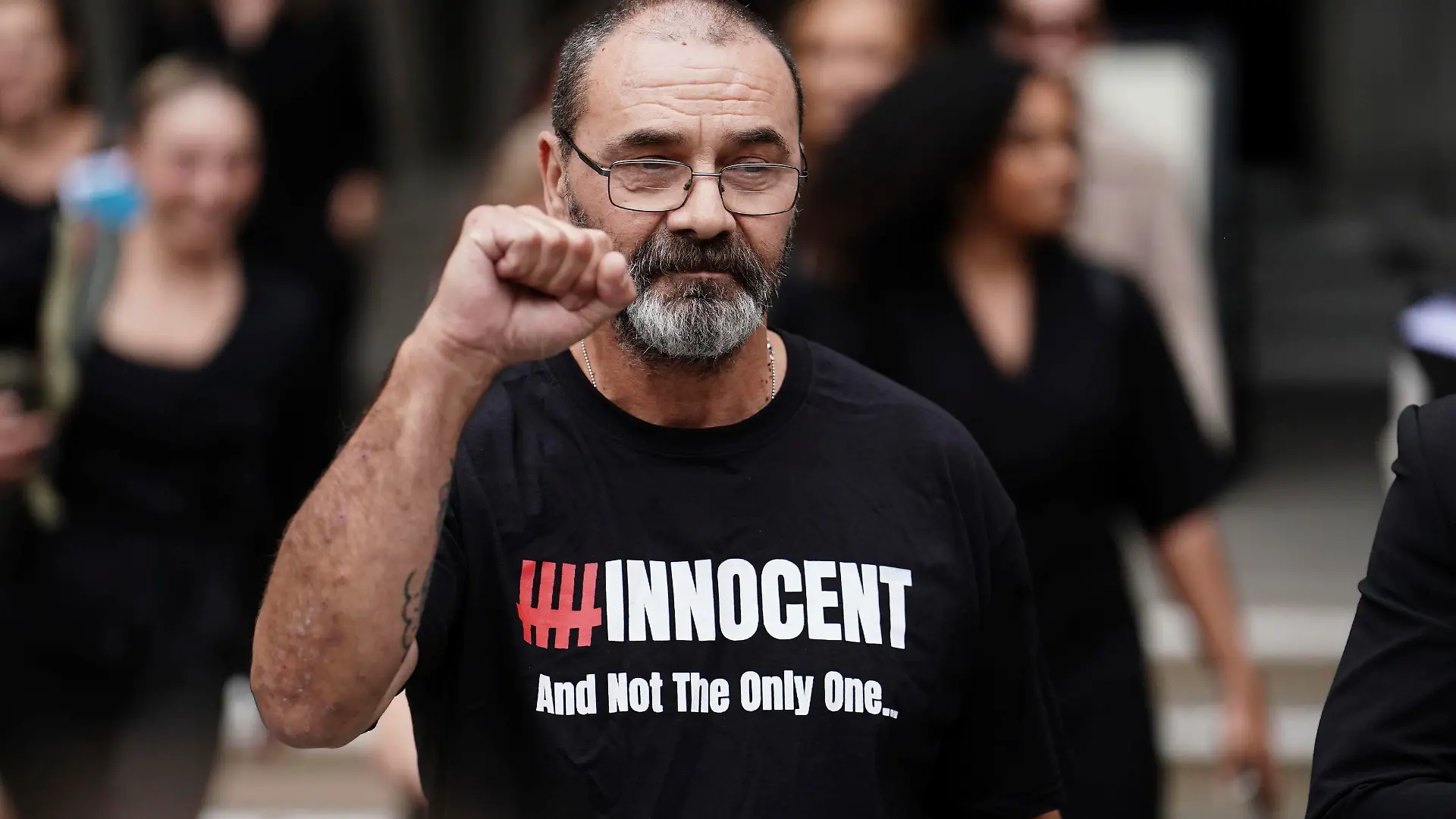 Andrew Malkinson raises a fist outside the Royal Courts of Justice in London, Britain, Wednesday, July 26, 2023. A British man who served nearly 17 years for rape has had his conviction quashed by the country’s Court of Appeal after recently-obtained DNA evidence linked another potential suspect to the crime. Andrew Malkinson, 57, was found guilty of the brutal 2003 attack on a woman in Greater Manchester and jailed for life the following year, with a minimum term of seven years. (Jordan Pettitt/PA via AP)