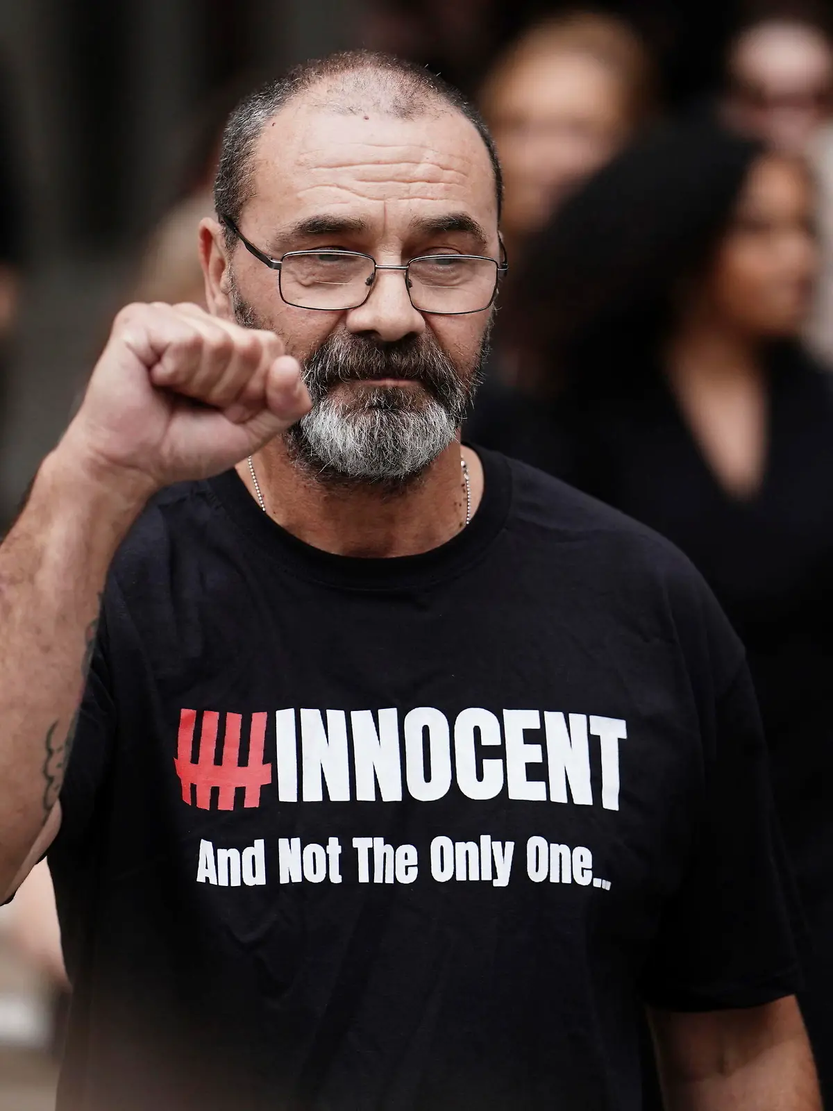 Andrew Malkinson raises a fist outside the Royal Courts of Justice in London, Britain, Wednesday, July 26, 2023. A British man who served nearly 17 years for rape has had his conviction quashed by the country’s Court of Appeal after recently-obtained DNA evidence linked another potential suspect to the crime. Andrew Malkinson, 57, was found guilty of the brutal 2003 attack on a woman in Greater Manchester and jailed for life the following year, with a minimum term of seven years. (Jordan Pettitt/PA via AP)