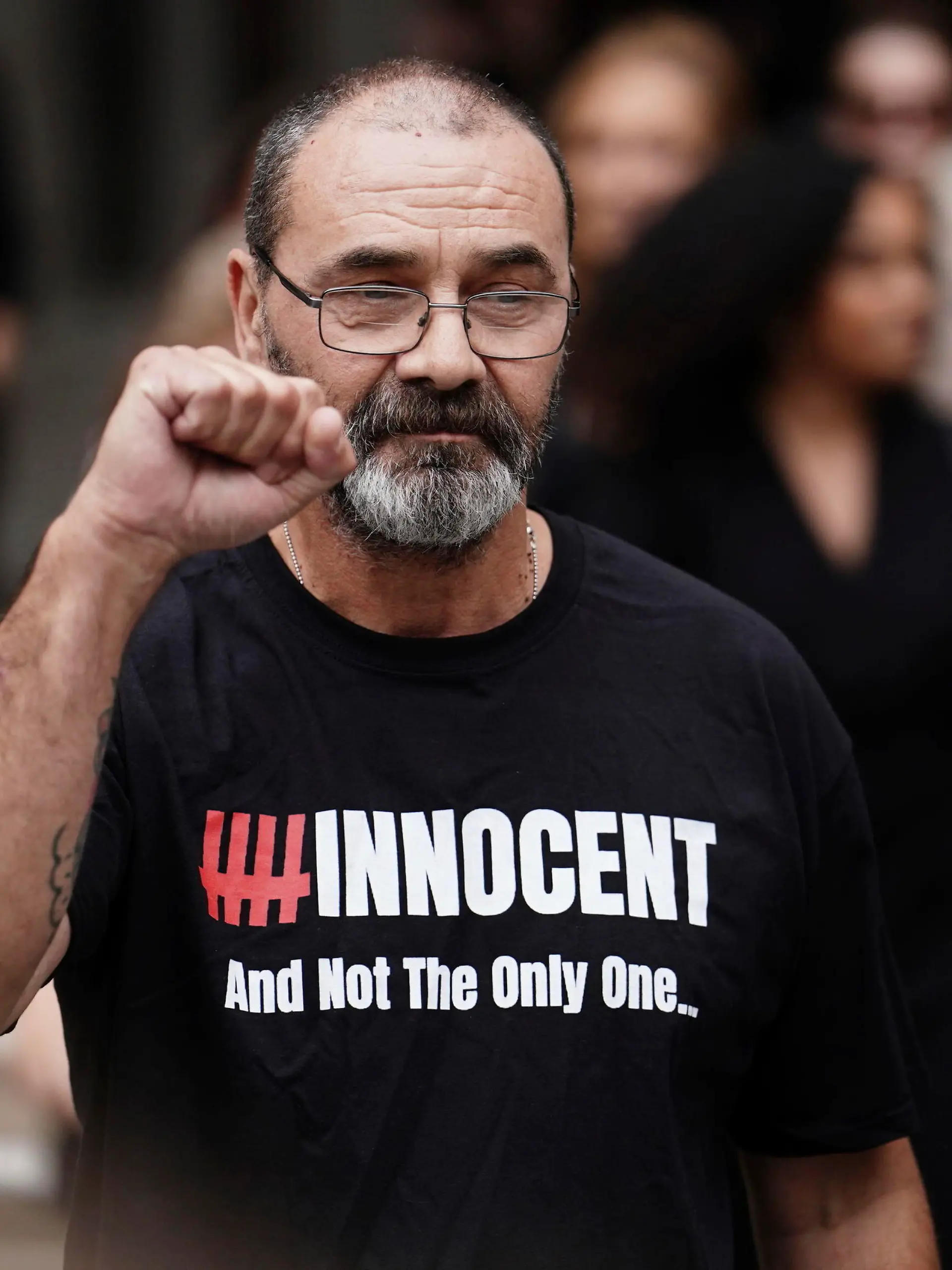 Andrew Malkinson raises a fist outside the Royal Courts of Justice in London, Britain, Wednesday, July 26, 2023. A British man who served nearly 17 years for rape has had his conviction quashed by the country’s Court of Appeal after recently-obtained DNA evidence linked another potential suspect to the crime. Andrew Malkinson, 57, was found guilty of the brutal 2003 attack on a woman in Greater Manchester and jailed for life the following year, with a minimum term of seven years. (Jordan Pettitt/PA via AP)