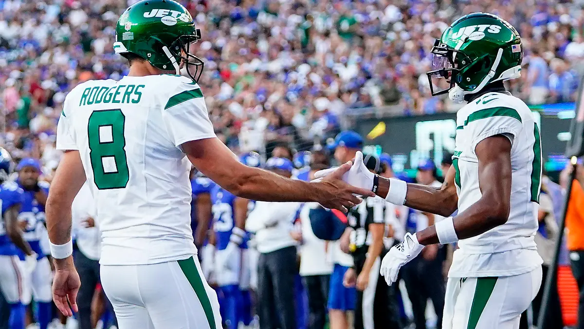New York Jets quarterback Aaron Rodgers (8) congratulates wide receiver Garrett Wilson (17) after Wilson's touchdown catch during the first half of an NFL preseason football game against the New York Giants, Saturday, Aug. 26, 2023, in East Rutherford, N.J. (AP Photo/Frank Franklin II)