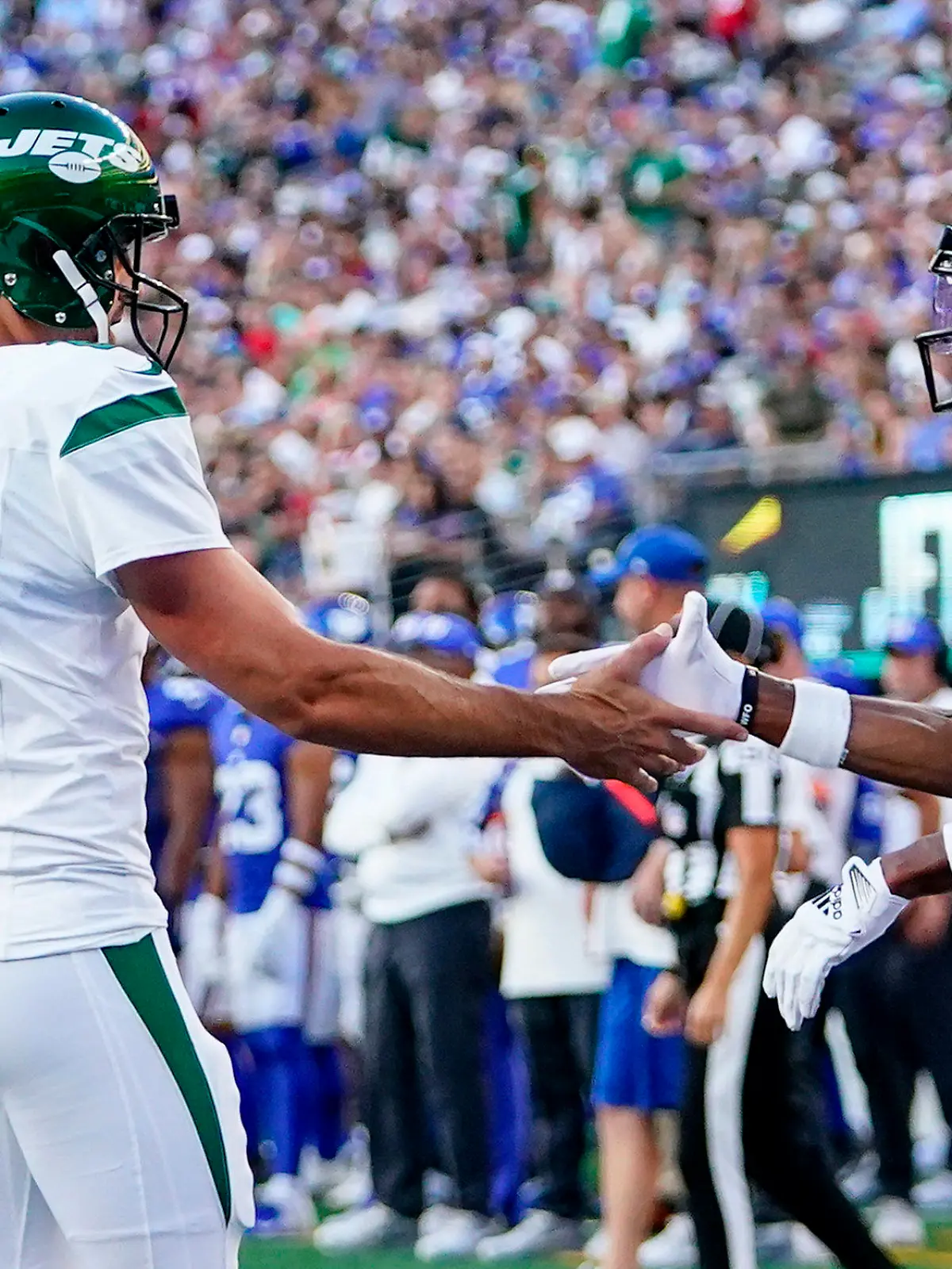 New York Jets quarterback Aaron Rodgers (8) congratulates wide receiver Garrett Wilson (17) after Wilson's touchdown catch during the first half of an NFL preseason football game against the New York Giants, Saturday, Aug. 26, 2023, in East Rutherford, N.J. (AP Photo/Frank Franklin II)