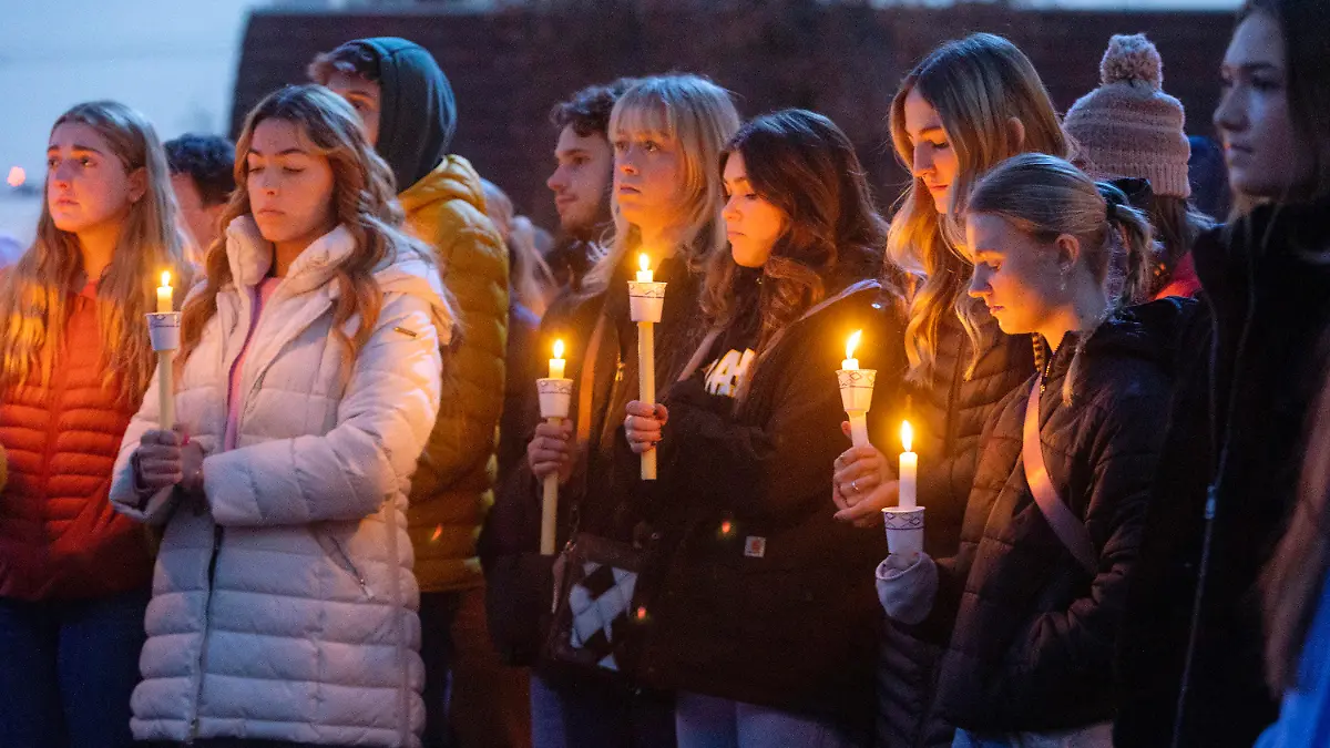Boise State University students, along with people who knew the four University of Idaho students who were found killed in Moscow, Idaho, days earlier, pay their respects at a vigil held in front of a statue on the Boise State campus, Thursday, Nov. 17, 2022, in Boise, Idaho. Autopsies performed on the four students who were found dead inside a rental house near campus showed that all four were stabbed to death, the Latah County coroner said. (Sarah A. Miller/Idaho Statesman via AP)