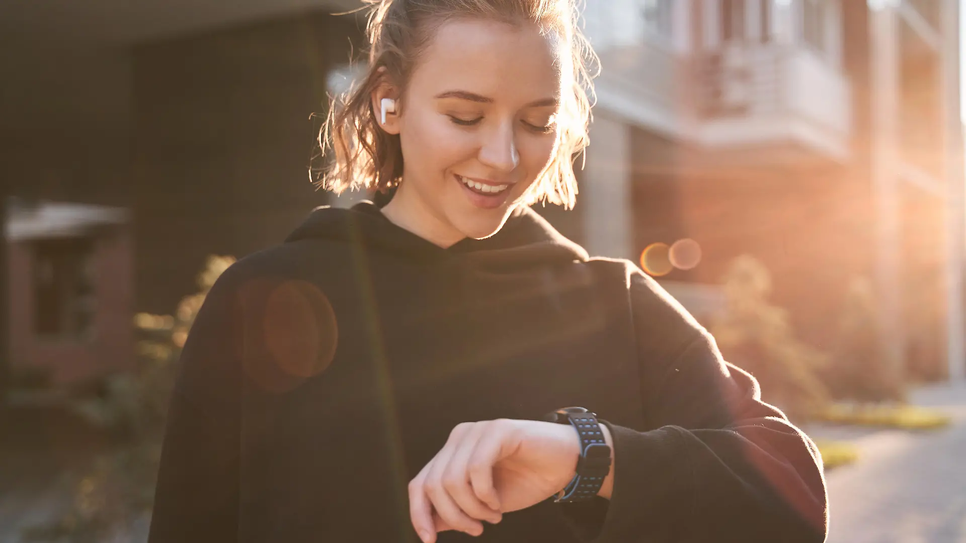Fitness woman checking results on smartwatch in fitness app after workout session. Female athlete wearing sport tracker wristband arm. Healthy lifestyle concept