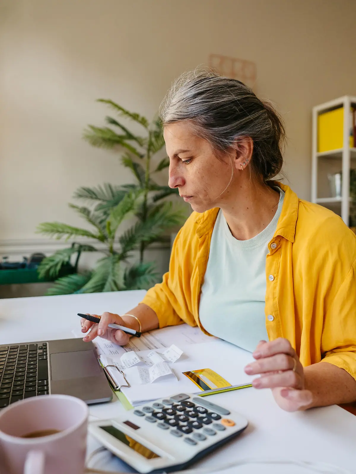 Photo of a woman calculating and paying online her income tax