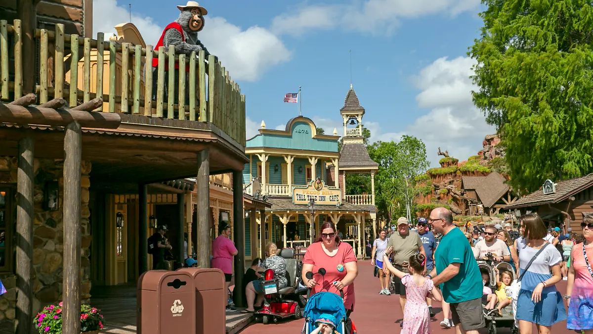 FILE - A performer dressed as a bear from the Country Bear Jamboree show entertains visitors from a deck at Magic Kingdom Park at Walt Disney World Resort in Lake Buena Vista, Florida, on April 22, 2022. It wasn't an escapee from the Country Bear Jamboree attraction, but a wild black bear managed to be the star of its own show Monday Sept. 18 2023 at Walt Disney World. The presence of the black bear in a tree in the Magic Kingdom delayed the opening of three lands Monday morning — Frontierland, Liberty Square and Adventureland. (AP Photo/Ted Shaffrey file)