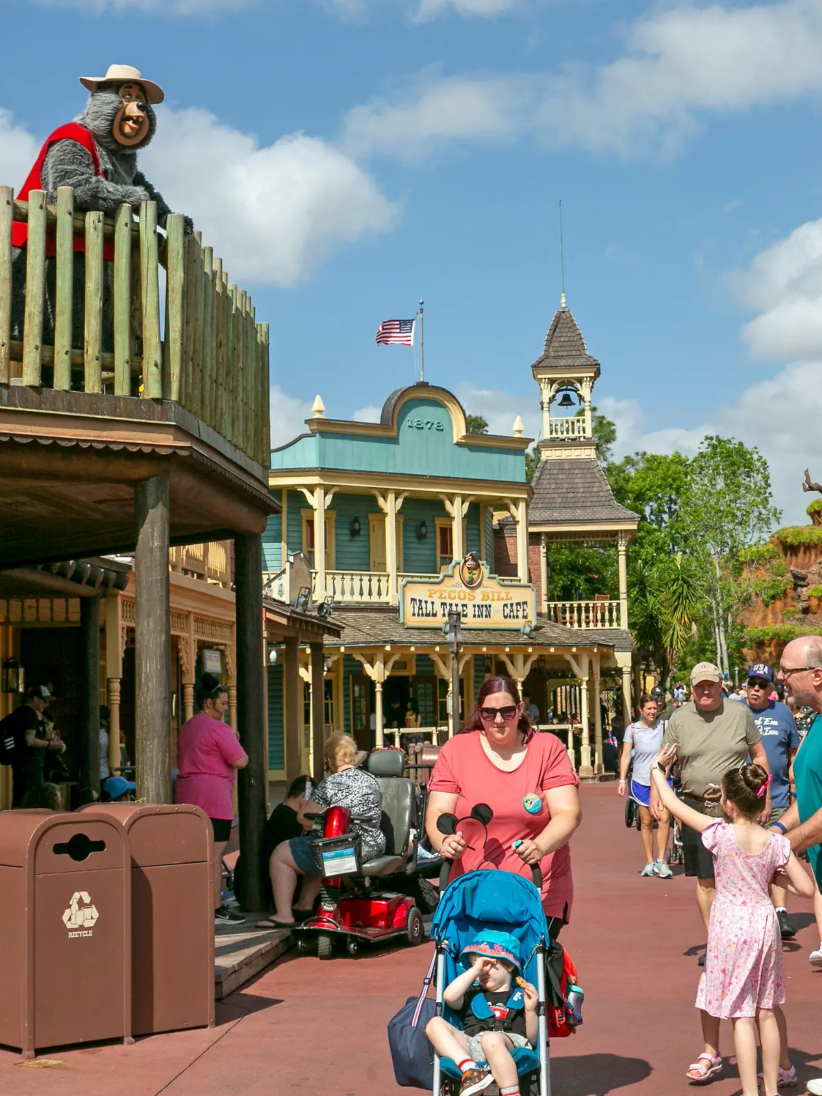 FILE - A performer dressed as a bear from the Country Bear Jamboree show entertains visitors from a deck at Magic Kingdom Park at Walt Disney World Resort in Lake Buena Vista, Florida, on April 22, 2022. It wasn't an escapee from the Country Bear Jamboree attraction, but a wild black bear managed to be the star of its own show Monday Sept. 18 2023 at Walt Disney World. The presence of the black bear in a tree in the Magic Kingdom delayed the opening of three lands Monday morning — Frontierland, Liberty Square and Adventureland. (AP Photo/Ted Shaffrey file)