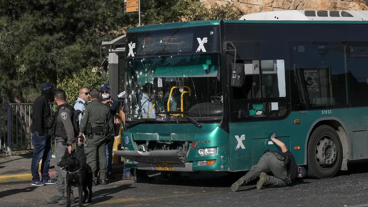 Israeli police inspect the scene of an explosion at a bus stop in Jerusalem, Wednesday, Nov. 23, 2022. Two blasts have gone off near bus stops in Jerusalem, killing one person and injuring at least 14, in what Israeli police said were suspected attacks by Palestinians. (AP Photo/Mahmoud Illean)