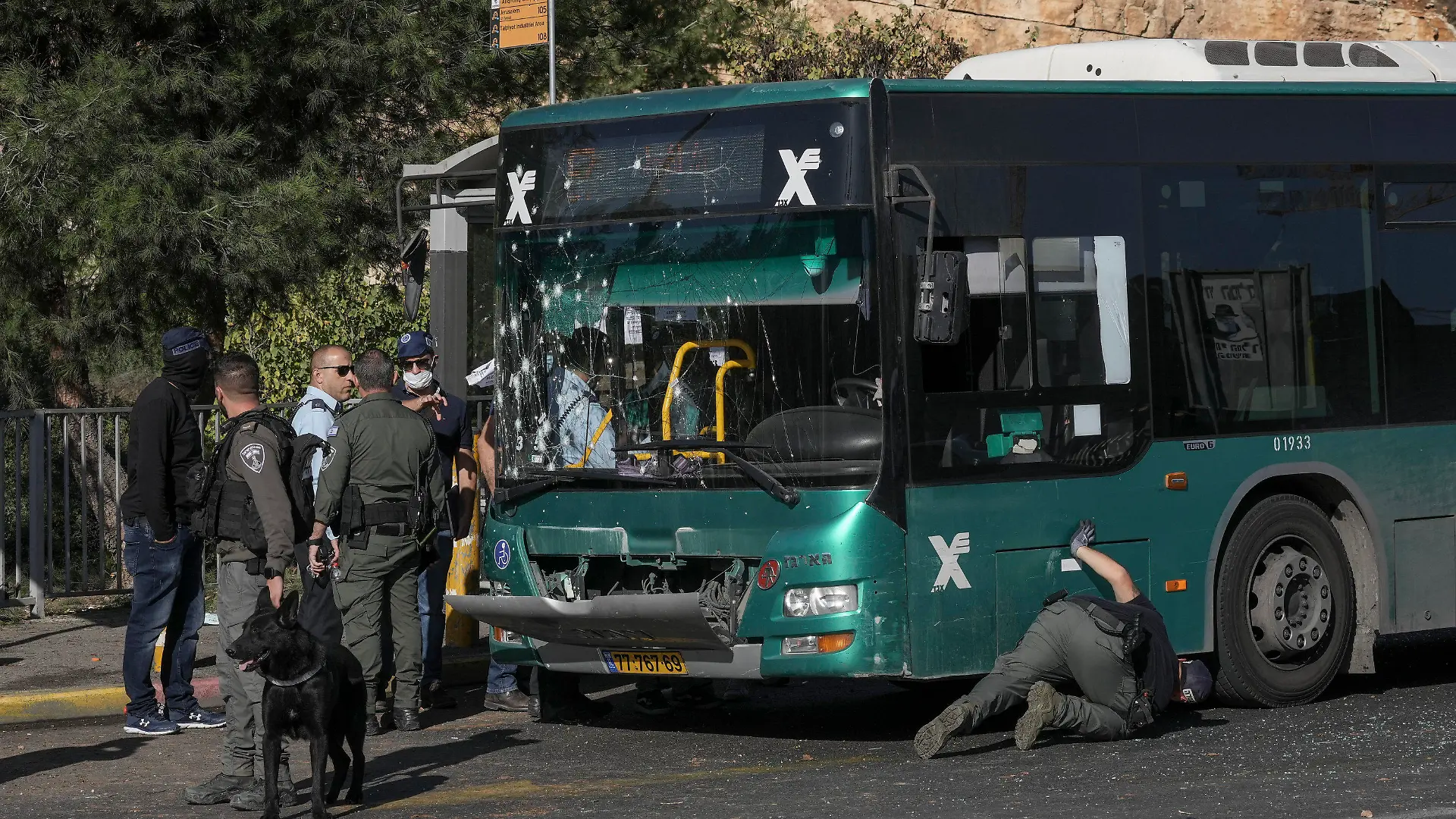 Israeli police inspect the scene of an explosion at a bus stop in Jerusalem, Wednesday, Nov. 23, 2022. Two blasts have gone off near bus stops in Jerusalem, killing one person and injuring at least 14, in what Israeli police said were suspected attacks by Palestinians. (AP Photo/Mahmoud Illean)