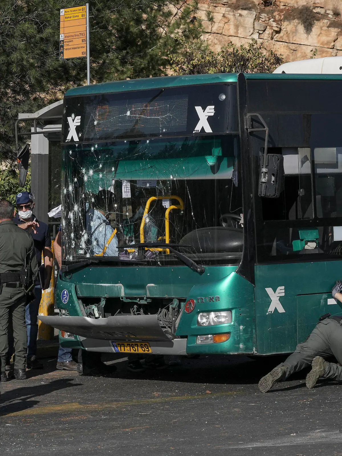 Israeli police inspect the scene of an explosion at a bus stop in Jerusalem, Wednesday, Nov. 23, 2022. Two blasts have gone off near bus stops in Jerusalem, killing one person and injuring at least 14, in what Israeli police said were suspected attacks by Palestinians. (AP Photo/Mahmoud Illean)