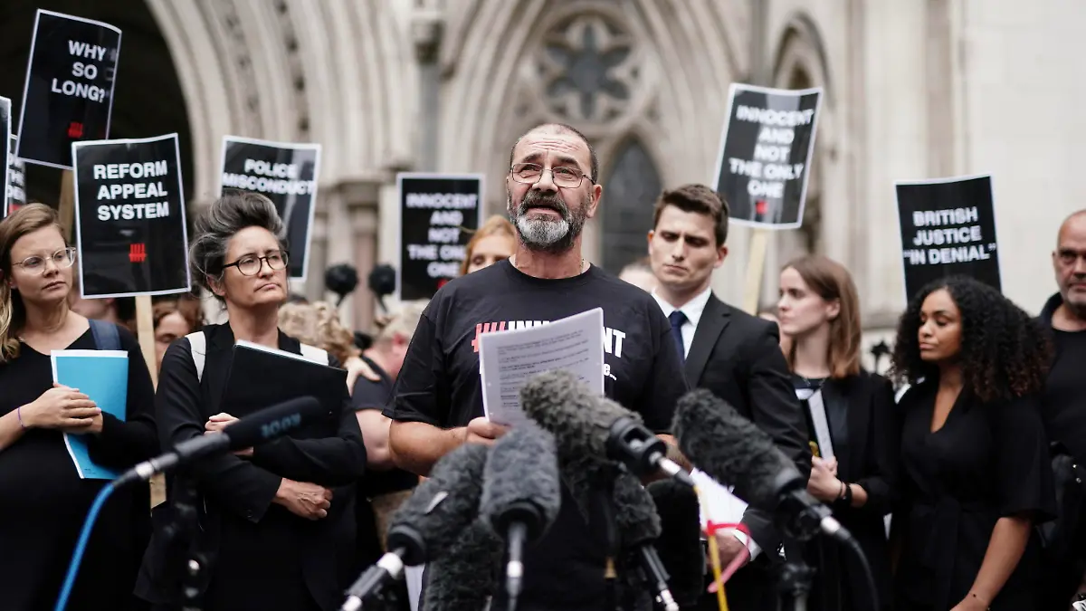 Andrew Malkinson, front, reads a statement after he left the Royal Courts of Justice in London, Britain, Wednesday, July 26, 2023. A British man who served nearly 17 years for rape has had his conviction quashed by the country’s Court of Appeal after recently-obtained DNA evidence linked another potential suspect to the crime. Andrew Malkinson, 57, was found guilty of the brutal 2003 attack on a woman in Greater Manchester and jailed for life the following year, with a minimum term of seven years. (Jordan Pettitt/PA via AP)