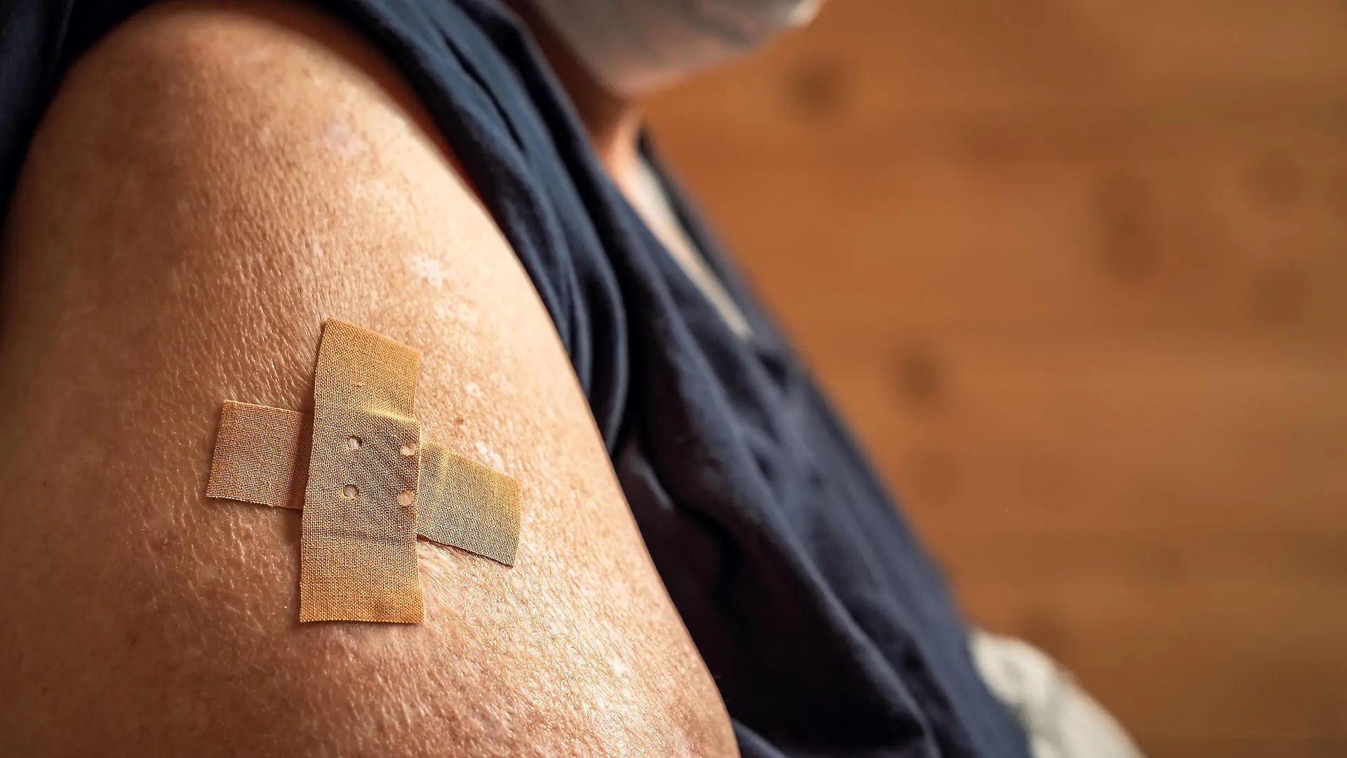 Mindelheim, Bavaria, germany - 01 may 2021: overweight woman shows her arm after being vaccinated. arm with adhesive bandage after injection. Health concept