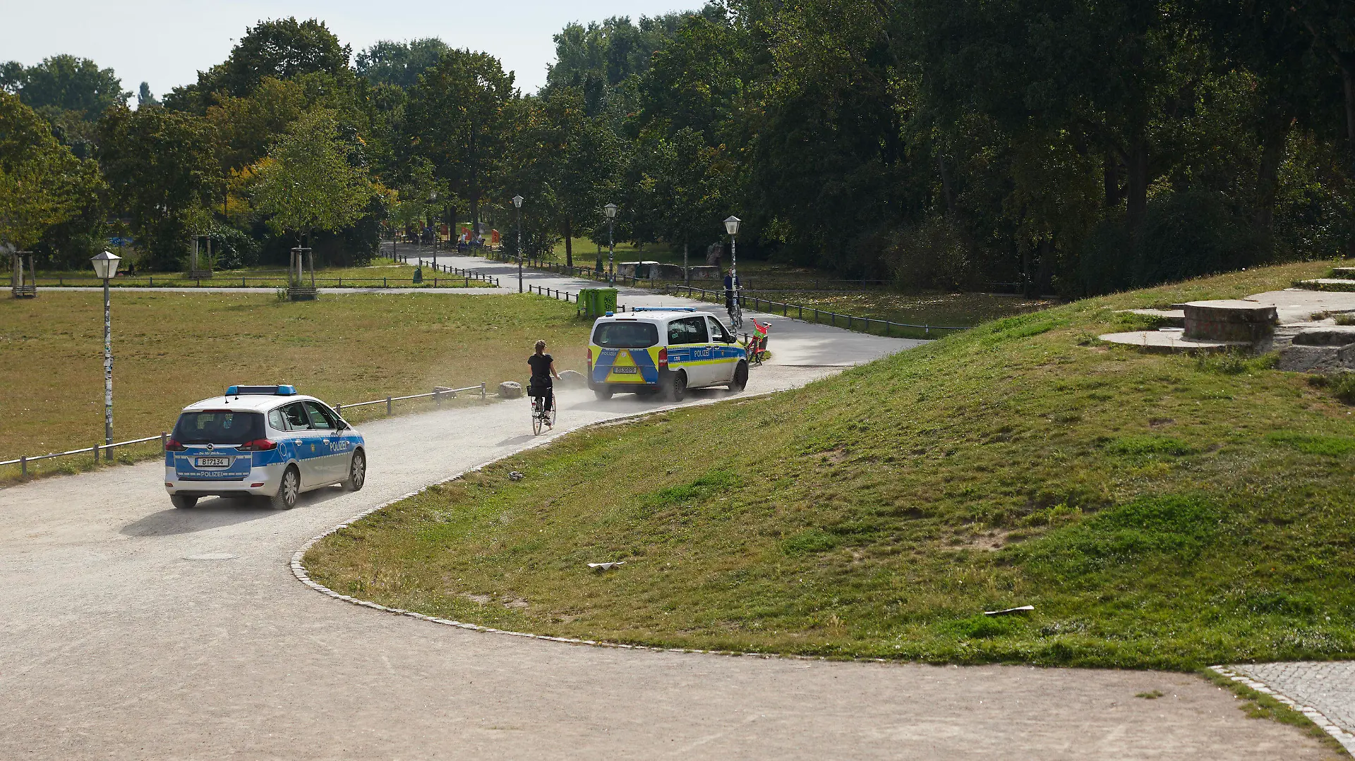 18.09.2023, Berlin: Polizeikräfte fahren durch den Görlitzer Park. Nach dem Willen von Berlins Innensenatorin Spranger soll die bestehende Mauer um den Görlitzer Park in Kreuzberg komplett abgerissen werden, um die Sicherheit zu erhöhen. Das Bauwerk biete Dealern und anderen Kriminellen einen Sichtschutz, der sie zu Straftaten verführen könnte, argumentiert die SPD-Politikerin nach einem Bericht der «Berliner Morgenpost». Foto: Jörg Carstensen/dpa +++ dpa-Bildfunk +++