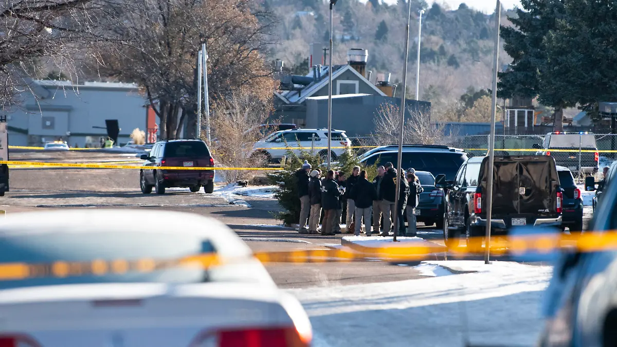 Law enforcement personnel stand outside of the scene of a mass shooting at Club Q, a gay bar in Colorado Springs, Colo., on Sunday, Nov. 20, 2022. A 22-year-old gunman opened fire in the gay nightclub, killing at least five people and leaving multiple others injured before he was subdued by “heroic” patrons and arrested by police who were on the scene within minutes, authorities said Sunday. (Parker Seibold/The Gazette via AP)
