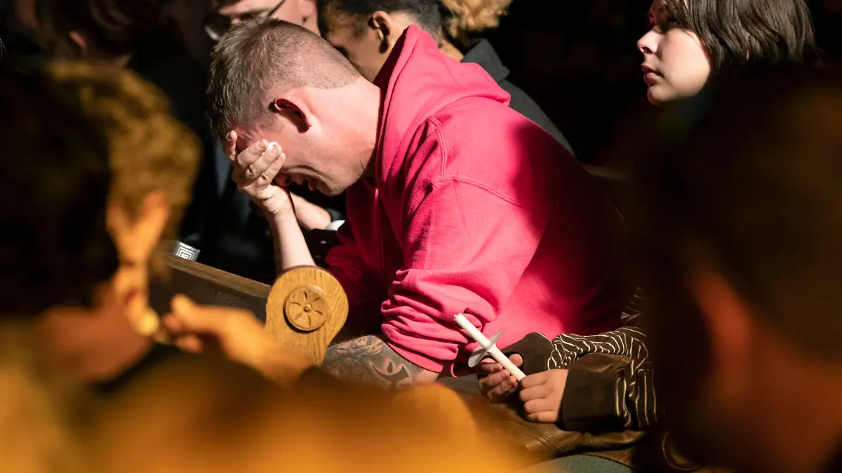 R.J. Lewis sobs in the pews of All Souls Unitarian Church at the start of a service held for people to mourn following a fatal shooting at Club Q in Colorado Springs, Colo., on Sunday, Nov. 20, 2022. Lewis was at the club when the shooting occurred Saturday night. (Parker Seibold/The Gazette via AP)