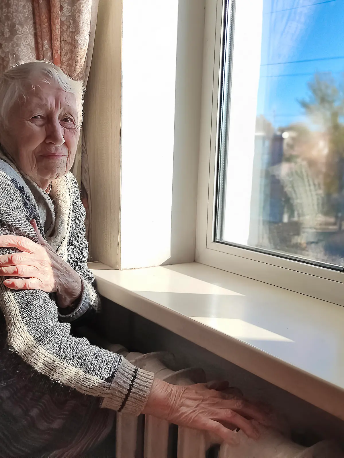 Freezing old people in Europe. The senior woman in bed at home. Payment for heating in winter. The gas crisis has led to an increase in gas prices