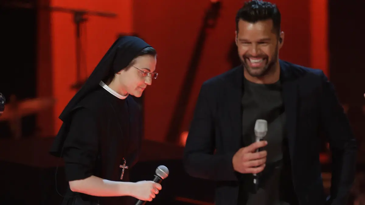 Italian singer Suor Cristina Scuccia, left, and Ricky Martin perform during the Italian State RAI TV program "The Voice of Italy", in Milan, Italy, Wednesday, May 28, 2014. (AP Photo/Luca Bruno)