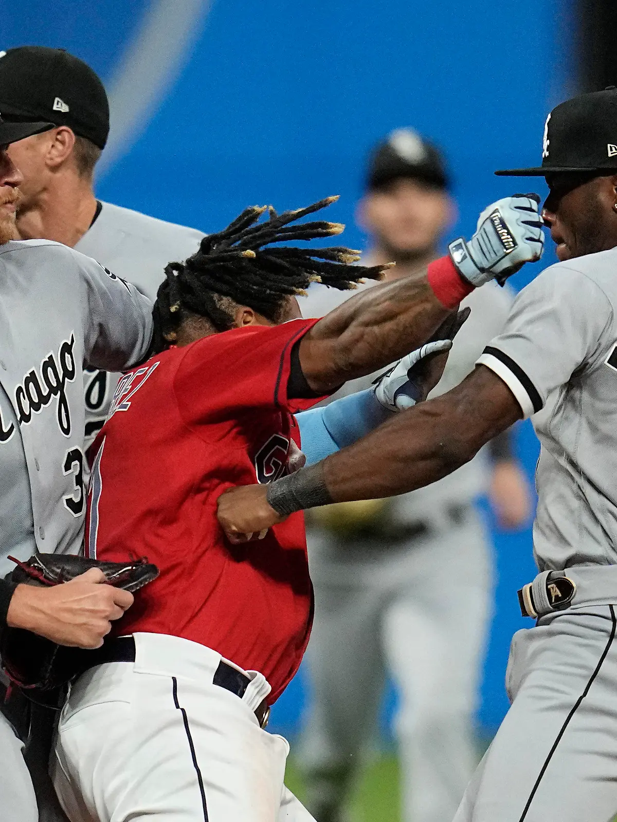 Cleveland Guardians' Jose Ramirez, center, and Chicago White Sox's Tim Anderson (7) exchange punches in the sixth inning of a baseball game Saturday, Aug. 5, 2023, in Cleveland. White Sox's Michael Kopech, left looks on. (AP Photo/Sue Ogrocki)
