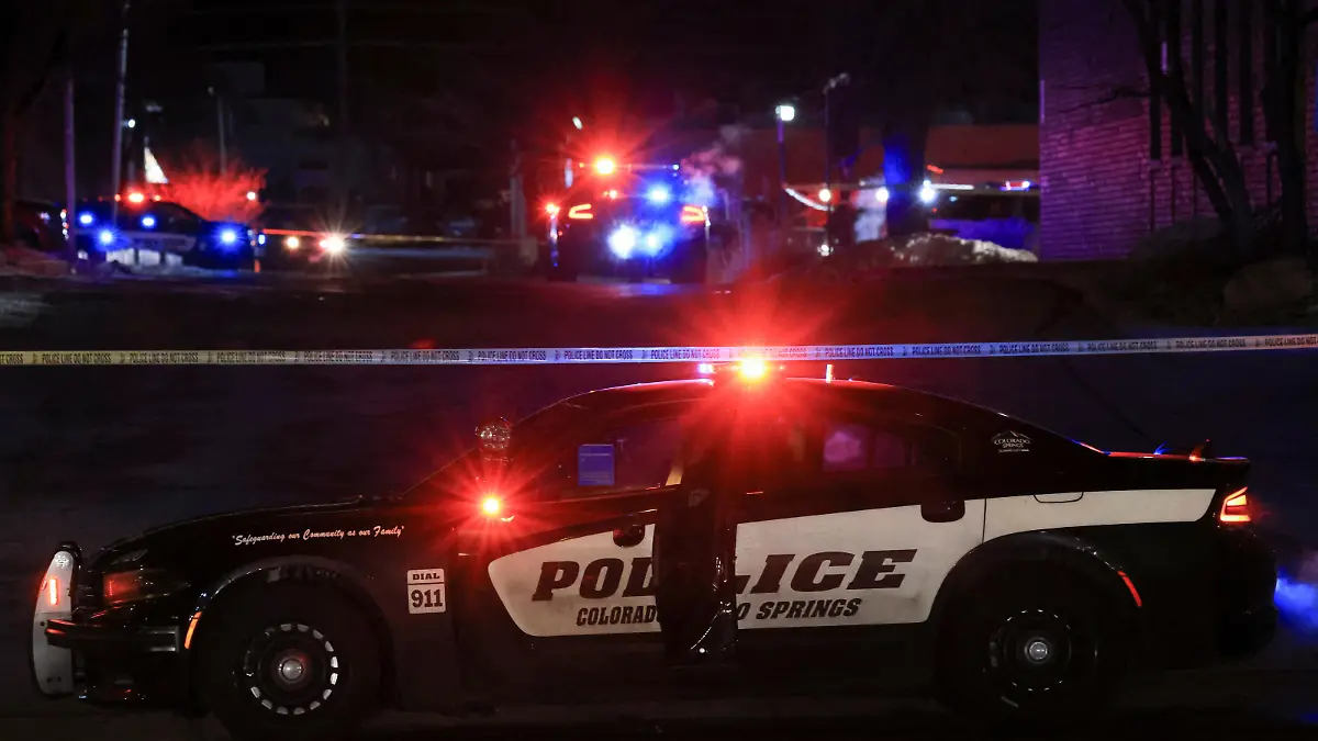 A police officer sits in their vehicle while responding to a mass shooting at the Club Q gay nightclub in Colorado Springs, Colorado, U.S., November 20, 2022. REUTERS/Kevin Mohatt
