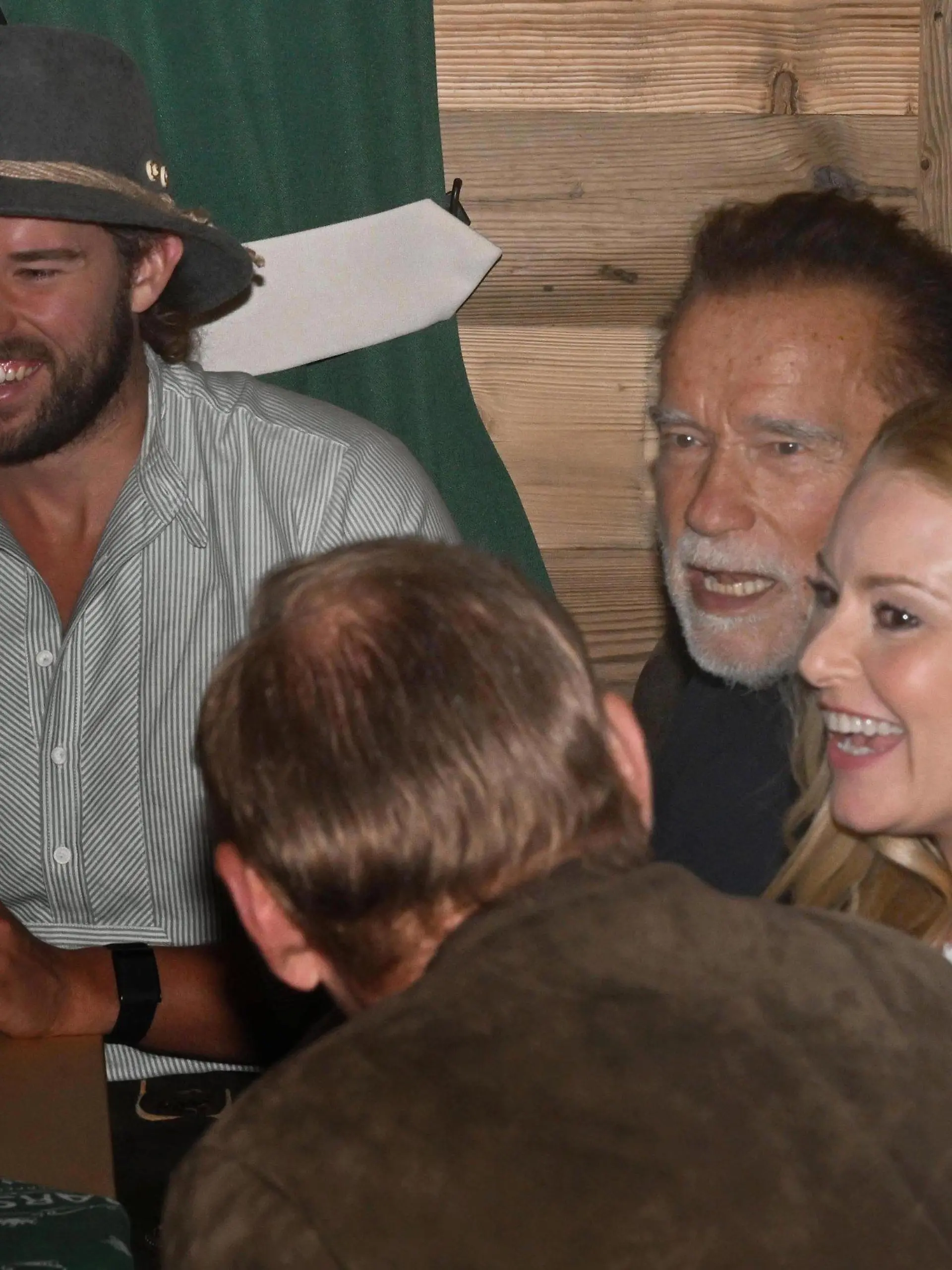 21.09.2023, Bayern, München: Christopher Schwarzenegger (l-r), der Sohn von Arnold Schwarzenegger, der Schauspieler Arnold Schwarzenegger und seine Freundin Heather Milligan feiern im Marstallzelt. Die 188. Wiesn findet dieses Jahr vom 16.09.- 03.10.2023 statt. Foto: Felix Hörhager/dpa +++ dpa-Bildfunk +++